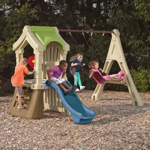 beige and green outdoor playhouse with swings and blue slide for kids
